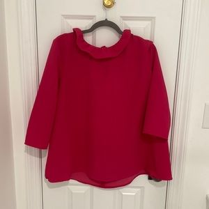 Woman’s Pink Top with riffle neck.